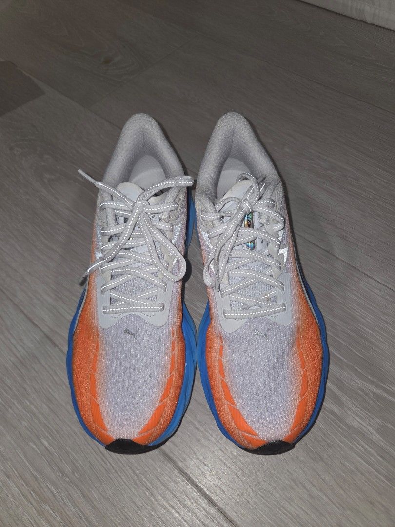Puma velocity nitro 4 - White/Orange/Blue (Category: Sneakers) located in Pasig City. Submitted by igotchugirl (Listing ID 1444177104, Image 3). Description: - Puma running shoes - Color: White with orange and blue accents - Laces: Grey worn once - Condition: Worn Once - Includes original box - Ideal for running.
