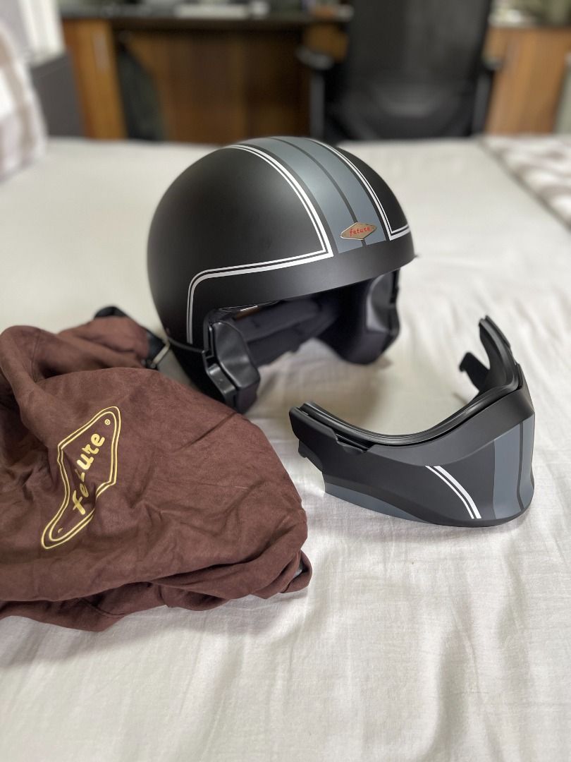 RUSH SALE: Modular Vintage Style Helmet (Category: Helmets and other Riding Gears) located in Taguig. Submitted by vestie872 (Listing ID 1444200029, Image 3). Description: - Modular helmet with a vintage aesthetic - Matte black finish with silver and grey racing stripe details - Clear visor for unobstructed vision - Ideal for motorcycle riders seeking style and functionality - Available for a limited time (rush sale) Brand new but without box Bou