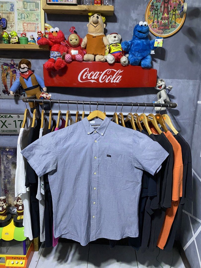 RVCA Slim Fit Button Up Shirt Size L (Category: Tshirts & Polo Shirts ) located in Santa Ana. Submitted by tunes_vtg (Listing ID 1444252332, Image 1). Description: - Brand: RVCA - Style: Short-sleeve button-up shirt - Fit: Slim fit - Size: L - Color: Light blue - Features: Subtle texture, small chest pocket with RVCA logo, button-down collar - Origin: Made in Vietnam - Condition: Minor snag on the front (refer to the last picture for details) - D