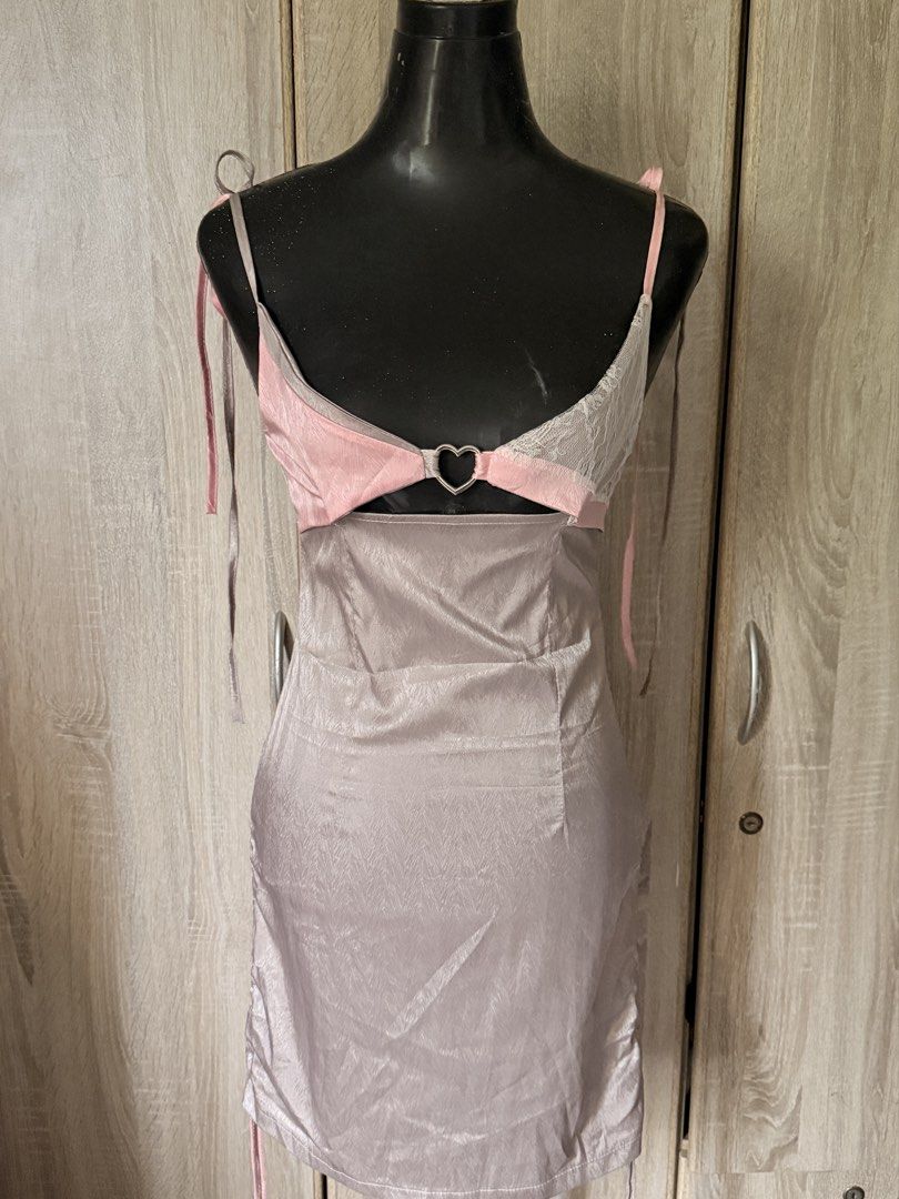 sexy self tie dress (Category: Dresses) located in Caloocan City. Submitted by prettyplease000 (Listing ID 1444300454, Image 1). Description: s-m frame only - Adorable mini dress with a pink and grey color block top. - Features a charming heart-shaped cutout in the front. - Adjustable tie straps for a customized fit. - Skirt has a subtle shimmer and stylish side ruching. - Convenient back zipper closure. - Ideal for a night out or any special occ