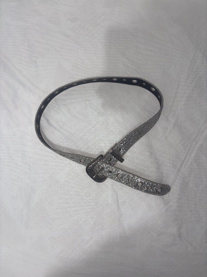 Sparkly Silver Glitter Belt with Buckle (Category: Belts) located in Manila. Submitted by thriftgodesa (Listing ID 1444276219, Image 1). Description: - Eye-catching silver glitter belt - Features a cool, ornate buckle - Multiple eyelets for adjustable and customizable sizing - Adds instant sparkle to any outfit - Versatile: looks great with jeans and dresses.