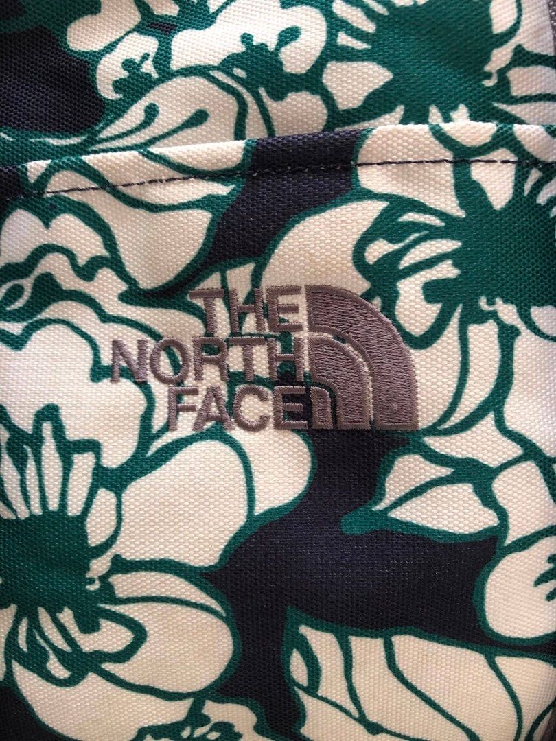 The North Face Floral Duffle Bag (Category: Sling Bags) located in Davao. Submitted by 4mscllection (Listing ID 1444178689, Image 2). Description: - Stylish floral print duffle bag from The North Face - Color: Navy blue with green and white flowers - Features a spacious main compartment - Includes internal pockets for organization - Comes with an adjustable shoulder strap - Ideal for weekend getaways or gym workouts.