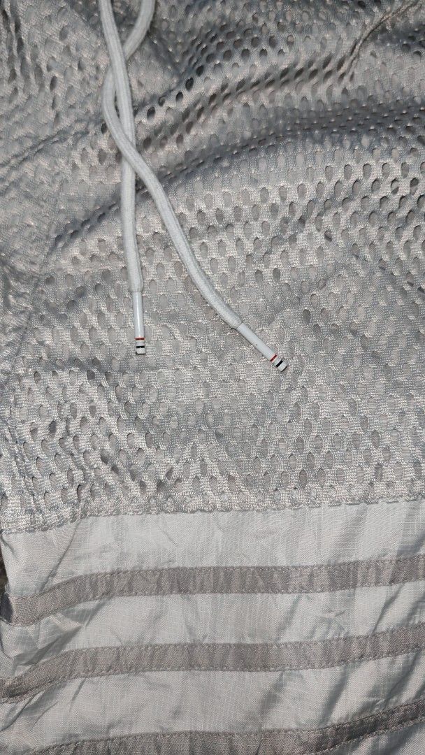Thom Browne Mesh Shorts with 4-Bar Stripe (Category: Luxury Apparel) located in Cotabato. Submitted by rayhan.thriftee (Listing ID 1444263249, Image 2). Description: - Authentic Thom Browne Grey Mesh Shorts - Signature 4-Bar Stripe Detail on Side - Elastic Waistband with Drawstring - Made in Italy - Ideal for Casual Wear or Lounging.