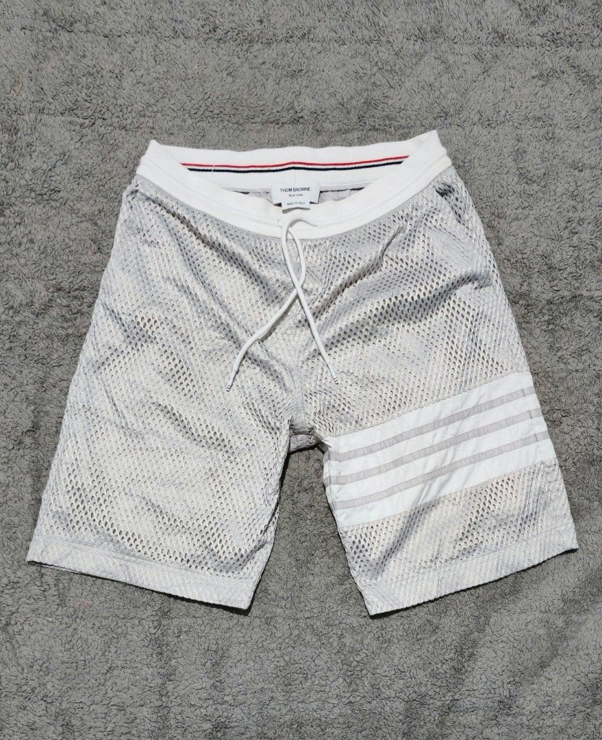Thom Browne Mesh Shorts with 4-Bar Stripe (Category: Luxury Apparel) located in Cotabato. Submitted by rayhan.thriftee (Listing ID 1444263249, Image 1). Description: - Authentic Thom Browne Grey Mesh Shorts - Signature 4-Bar Stripe Detail on Side - Elastic Waistband with Drawstring - Made in Italy - Ideal for Casual Wear or Lounging.