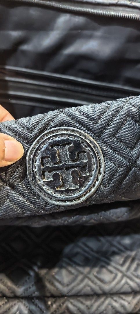 Tory Burch Black Quilted Tote Bag with Pouch (Category: Luxury Bags & Wallets) located in Cagayan de Oro. Submitted by tommygurl1218 (Listing ID 1444164374, Image 3). Description: - Tory Burch tote bag in classic black. - Elegant quilted pattern all over. - Includes a convenient matching front pouch. - Durable leather handles and trim. - Secure zipper closure for your belongings. - Stylish gold hardware details. - Ideal for everyday errands and a