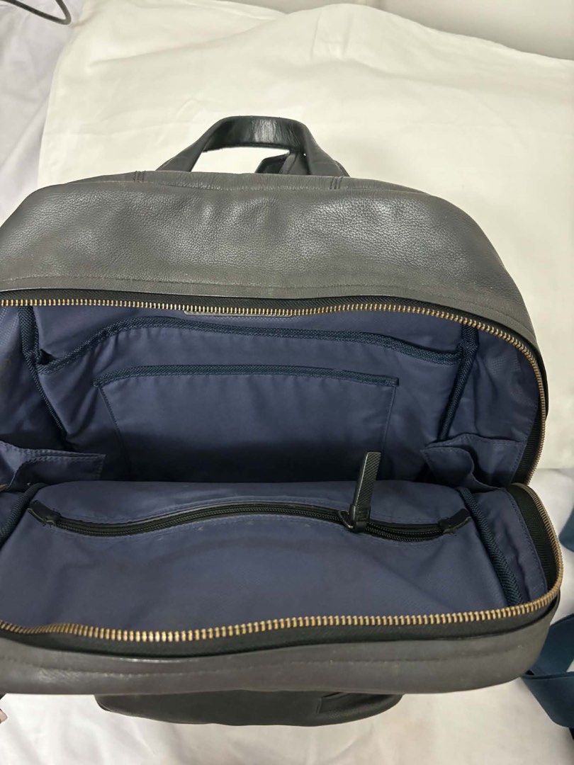 Tumi Mission Bryant laptop backpack (Category: Backpacks) located in Taguig. Submitted by maygm72703 (Listing ID 1444296386, Image 2). Description: Approximately 32 x 47 x 17 cm (roughly 12.6” L x 18.5” H x 6.7” W). Capacity: Often categorized as a medium to large-capacity bag, typically designed to fit a 15-inch laptop. Key Features:Material: High-quality black or iron gray leather. Compartments: One main zippered compartment, two prominent fron