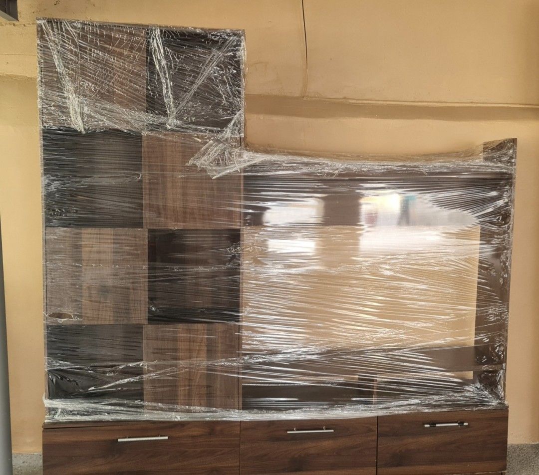 TV Rack with Cabinets, Shelves, Drawers (Category: Shelves, Cabinets & Racks) located in Quezon City. Submitted by Patrice_Shop (Listing ID 1421970446, Image 3). Description: - with chips in the laminates - Entertainment unit - Central space for TV - Multiple shelves and drawers for storage - Three bottom drawers - Dark brown laminate finish - Ideal for living room essentials.