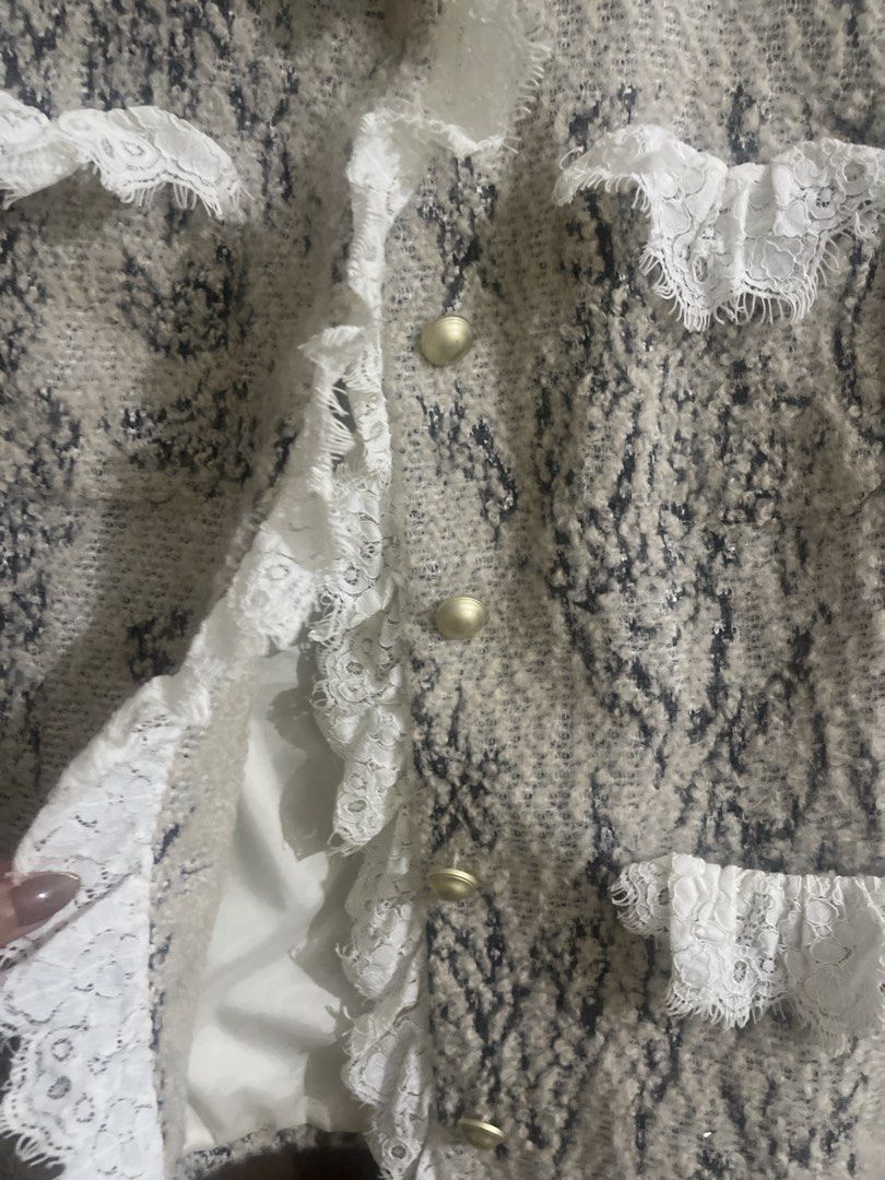 Tweed Jacket with Lace Trim and Ruffles (Category: Coats, Jackets and Outerwear) located in Manila. Submitted by mzclm (Listing ID 1444140850, Image 3). Description: - Elegant cream and black tweed jacket - Features delicate white lace trim and ruffles - Lace detailing along the front opening and pockets - Chic gold button closure - Adds a touch of sophistication to any outfit.