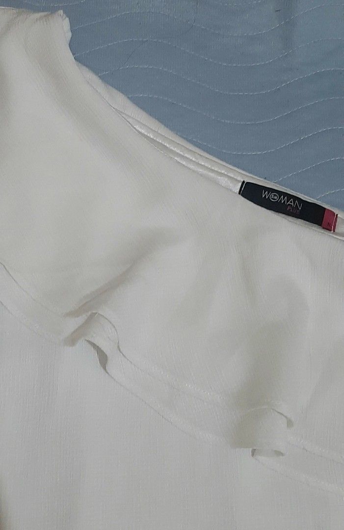 Woman Plus White One Shoulder Ruffle Top (Category: Sleeveless) located in Pasig City. Submitted by daffydaff (Listing ID 1444246636, Image 3). Description: - White one-shoulder top - Ruffle detail across the chest - Brand: Woman Plus - Minor flaw: Small mark inside (circled in last photo-unnoticeable) - Condition: Good - Plus size: 1L.