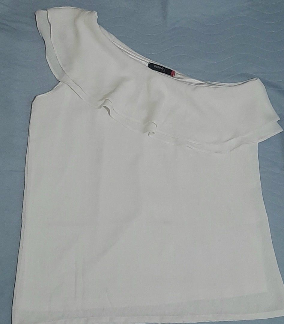 Woman Plus White One Shoulder Ruffle Top (Category: Sleeveless) located in Pasig City. Submitted by daffydaff (Listing ID 1444246636, Image 1). Description: - White one-shoulder top - Ruffle detail across the chest - Brand: Woman Plus - Minor flaw: Small mark inside (circled in last photo-unnoticeable) - Condition: Good - Plus size: 1L.