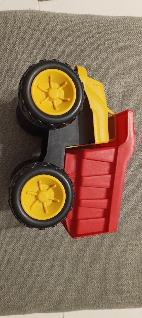 Yellow and Red Plastic Dump Truck Toy (Category: Kids Toys) located in Manila. Submitted by deeclutter_hub (Listing ID 1444224178, Image 2). Description: - Sturdy plastic dump truck - Bright yellow cab and red dump bed - Black wheels with yellow rims - Encourages imaginative play - Ideal for loading and unloading fun - Suitable for indoor and outdoor play.