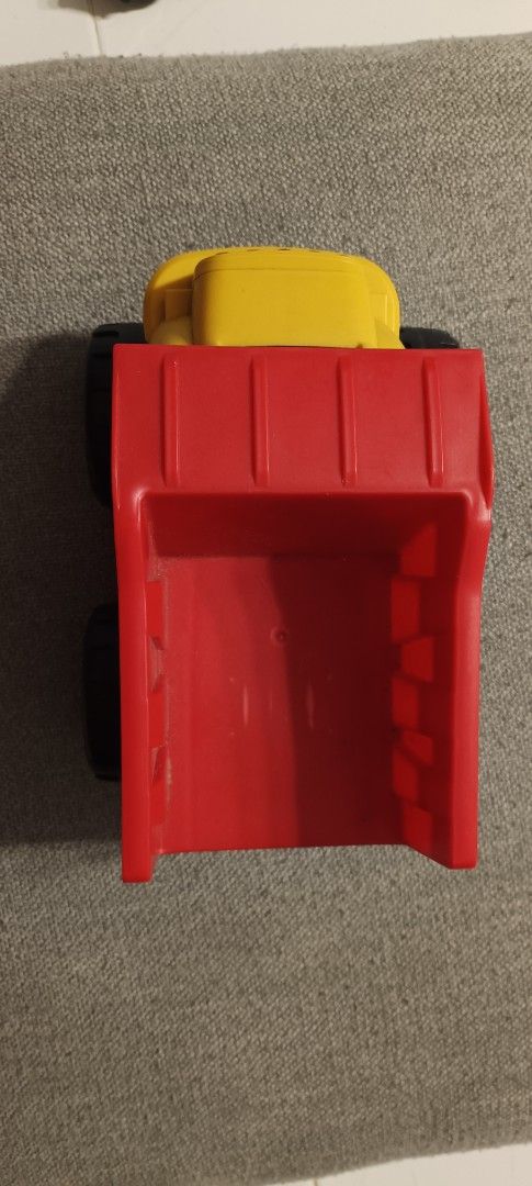 Yellow and Red Plastic Dump Truck Toy (Category: Kids Toys) located in Manila. Submitted by deeclutter_hub (Listing ID 1444224178, Image 3). Description: - Sturdy plastic dump truck - Bright yellow cab and red dump bed - Black wheels with yellow rims - Encourages imaginative play - Ideal for loading and unloading fun - Suitable for indoor and outdoor play.