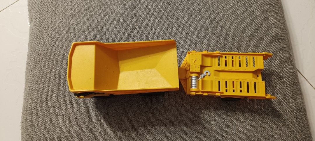 Yellow Dump Truck with Trailer Toy (Category: Kids Toys) located in Manila. Submitted by deeclutter_hub (Listing ID 1444225690, Image 3). Description: - Yellow dump truck toy - Detachable flatbed trailer - Truck bed lifts up - Made of durable plastic - Ideal for imaginative construction play - Great for kids who love construction vehicles.