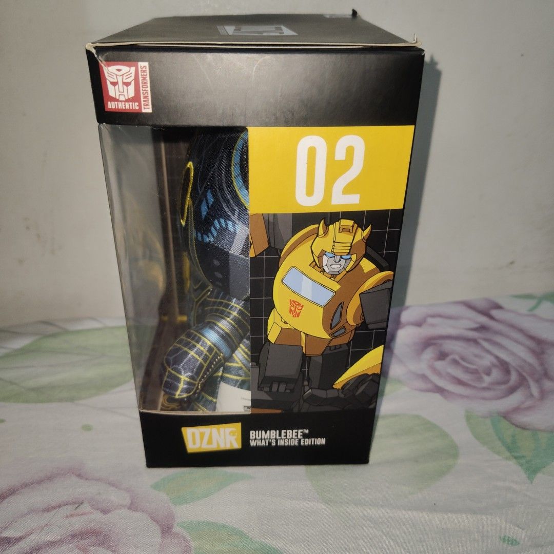 YuMe Transformers DZNR Bumblebee What's Inside Edition Plush (Category: Plushies & Soft Toys) located in Quezon City. Submitted by patric1218 (Listing ID 1444275769, Image 2). Description: - YuMe DZNR Transformers Bumblebee Plush - 'What's Inside Edition', Number 02 - Unique split design: shows both robot and car modes - Comes in original packaging - Ideal for any Transformers collector or fan.