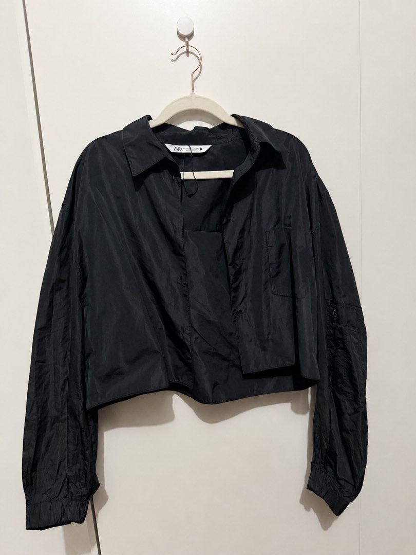 Zara Black Cropped Oversized Shirt Jacket (Category: Shirts) located in Manila. Submitted by deklutterph (Listing ID 1444284065, Image 1). Description: - Zara black shirt - Cropped and oversized fit - Button-up front with collar - Long sleeves with elasticated cuffs - Lightweight material - Versatile for layering or wearing solo.