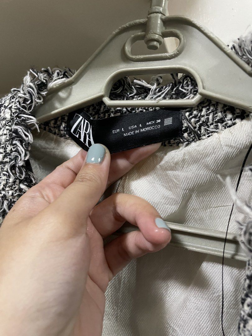 Zara Tweed Fringed Cropped Jacket (Category: Coats, Jackets and Outerwear) located in San Juan City. Submitted by miyakaandpark (Listing ID 1444302846, Image 3). Description: - Zara cropped jacket - Black and white tweed material - Stylish fringed edges on collar, cuffs, and pockets - Two front pockets with button closure - Fully lined interior - Made in Morocco - Perfect for dressing up or down.