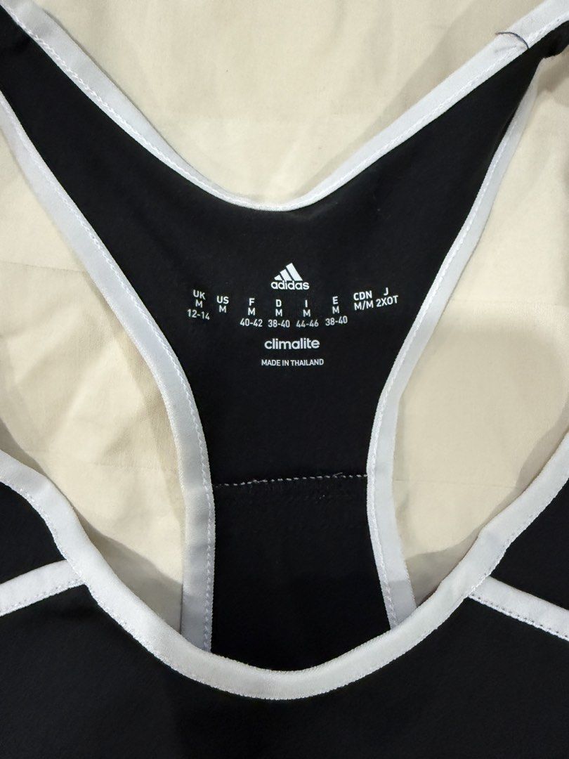 Adidas Climalite Black Tank Top (Category: Activewear) located in Quezon City. Submitted by jiafoo (Listing ID 1444496357, Image 2). Description: - Black Adidas tank top - Racerback style with white trim - Climalite fabric for breathability - Ideal for workouts or casual wear - Size: Medium.