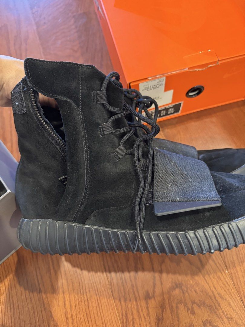 Adidas Yeezy Boost 750 Black Suede High Top Sneakers (Category: Sneakers) located in Singapore. Submitted by 9piter (Listing ID 1444390891, Image 2). Description: - Adidas Yeezy Boost 750 - Color: Black Suede - Size: US 12 - Design: High top with side zipper and ankle strap - Sole: Gum sole with Boost cushioning - Includes: Original box and Farfetch tag -StockX USD1k ++.
