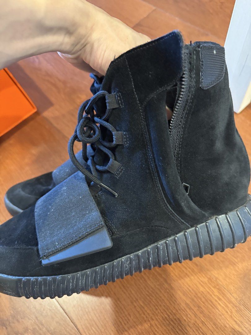Adidas Yeezy Boost 750 Black Suede High Top Sneakers (Category: Sneakers) located in Singapore. Submitted by 9piter (Listing ID 1444390891, Image 1). Description: - Adidas Yeezy Boost 750 - Color: Black Suede - Size: US 12 - Design: High top with side zipper and ankle strap - Sole: Gum sole with Boost cushioning - Includes: Original box and Farfetch tag -StockX USD1k ++.
