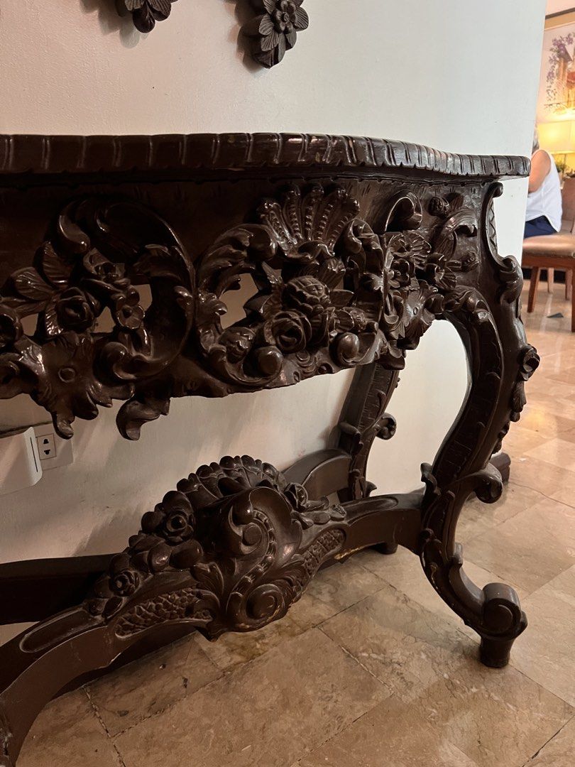 Antique Dark Wood Console Table with Ornate Mirror (Category: Tables & Sets) located in Paranaque City. Submitted by ohjustdecluttering (Listing ID 1444398643, Image 3). Description: - Beautifully carved dark wood console table and matching mirror set. - Features intricate floral and scroll details. - Table has a curved top and ornate legs. - Mirror has a highly decorative frame. - Adds vintage charm to any space. - Ideal for entryways or hallway