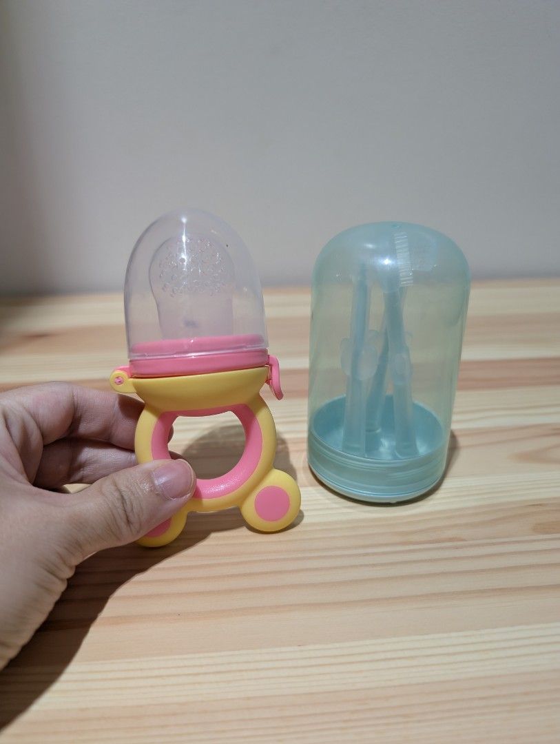 Baby Fruit Feeder Pacifier and Silicone Toothbrush Set (Category: Weaning & Toddler Feeding) located in Manila. Submitted by coolshark888 (Listing ID 1444329134, Image 1). Description: - Baby fruit feeder pacifier for safe food exploration. - Comes with soft silicone toothbrushes for gum and teeth cleaning. - Includes a transparent dust cover. - Designed for easy grip and to exercise baby's holding ability..