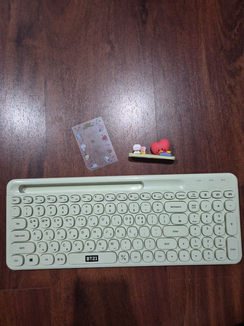 BTS BT21 Tata Wireless Keyboard (Category: Computer Keyboard) located in Caloocan City. Submitted by heonilatte (Listing ID 1444443745, Image 1). Description: Light green BTS BT21 Tata Wireless/Bluetooth Keyboard Comes with Tata photocard holder and transparent photocard frame. Figurine has adhesive tape on the bottom to attach to keyboard, but never attached it Pairs with up to 2 devices. Comes with USB dongle .