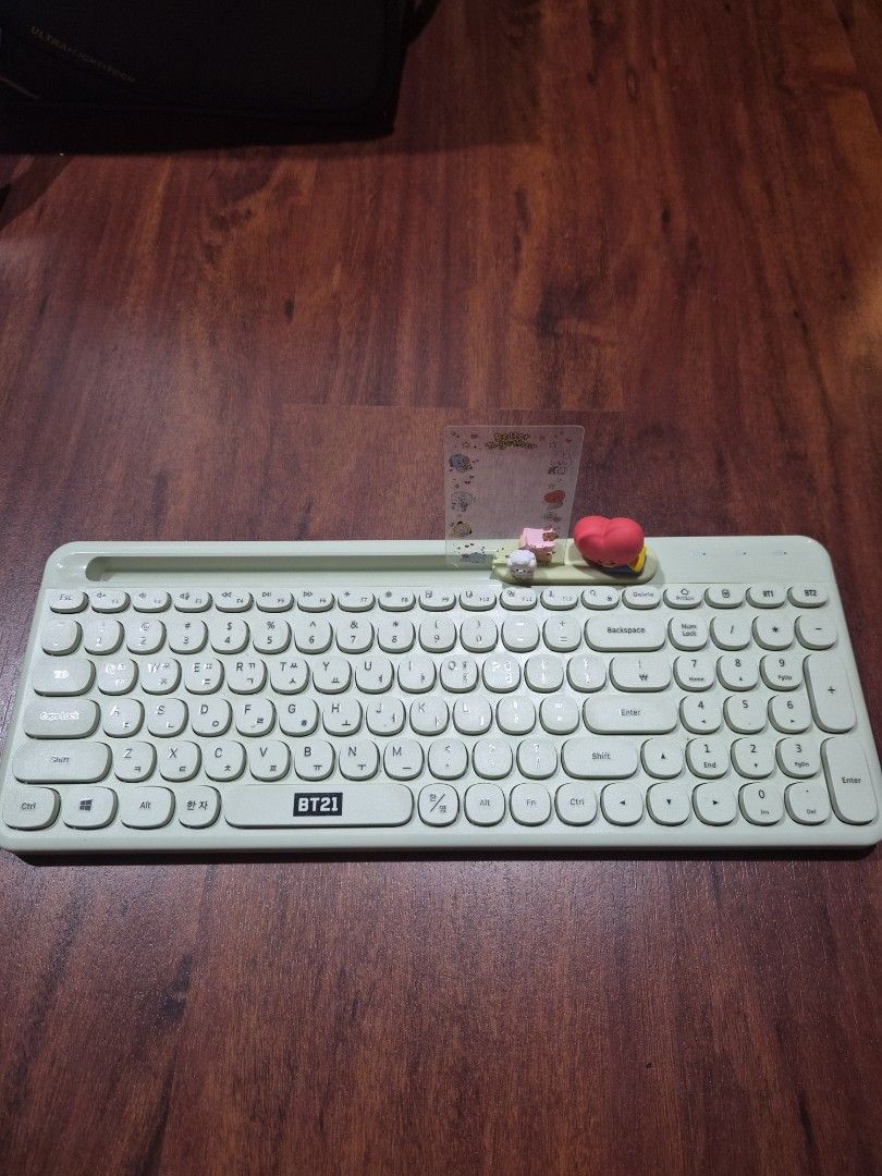 BTS BT21 Tata Wireless Keyboard (Category: Computer Keyboard) located in Caloocan City. Submitted by heonilatte (Listing ID 1444443745, Image 2). Description: Light green BTS BT21 Tata Wireless/Bluetooth Keyboard Comes with Tata photocard holder and transparent photocard frame. Figurine has adhesive tape on the bottom to attach to keyboard, but never attached it Pairs with up to 2 devices. Comes with USB dongle .
