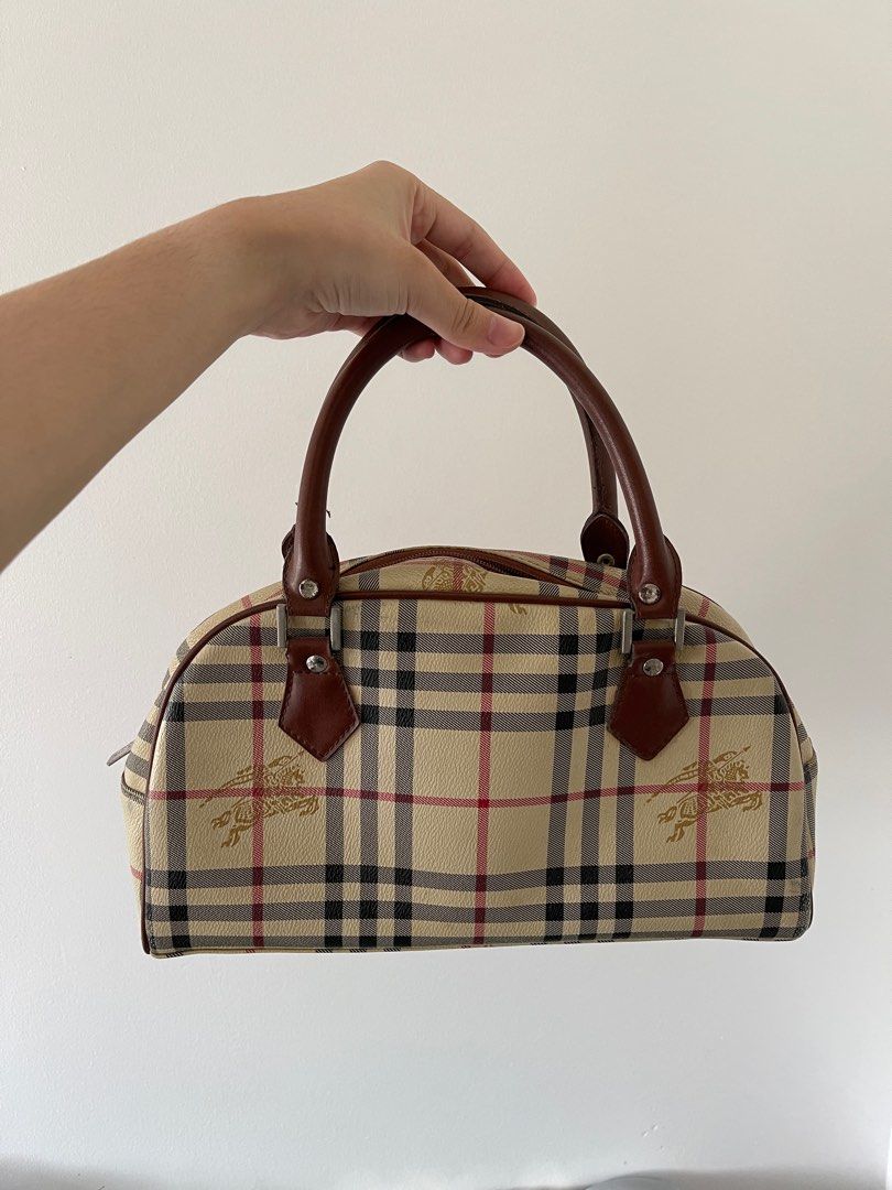 Burberry Blue Label Plaid Boston Bag (Category: Luxury Bags & Wallets) located in Lipa City. Submitted by alysjunk (Listing ID 1444356428, Image 3). Description: - Classic Burberry Blue Label Boston Bag - Iconic plaid pattern with equestrian knight details - Genuine leather trim and handles - Interior zippered pocket - Stylish and practical for everyday wear.