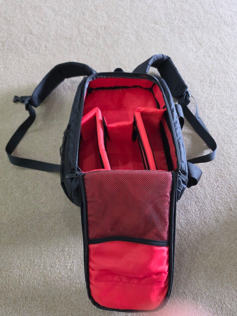 Camera Backpack (Category: Camera Bags & Carriers) located in Singapore. Submitted by sapfo (Listing ID 1444248624, Image 2). Description: - Stylish black camera backpack with eye-catching red accents. - Multiple zippered compartments to keep your camera and accessories organized. - Made from durable fabric for long-lasting use. - Top-attached straps for comfortable carrying. - Perfect for storing and transporting your camera staff..