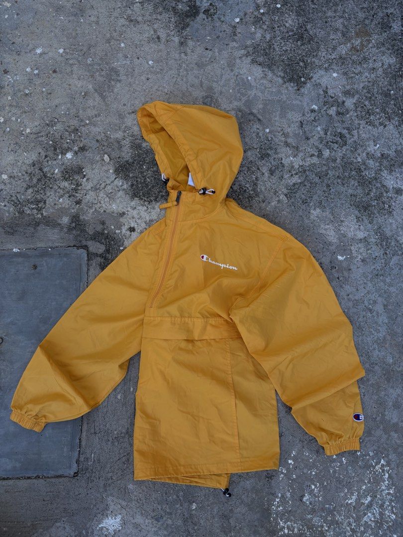 Champion Yellow Anorak Windbreaker Jacket (Category: Coats, Jackets and Outerwear) located in Consolacion. Submitted by hardy_303 (Listing ID 1444380588, Image 2). Description: - Yellow Champion anorak jacket - Hooded with a half-zip closure - Front kangaroo pocket with an additional zip pocket - Elastic cuffs and hem for a snug fit - Small Champion logo details on chest and sleeve - Ideal for layering or protection against light rain.