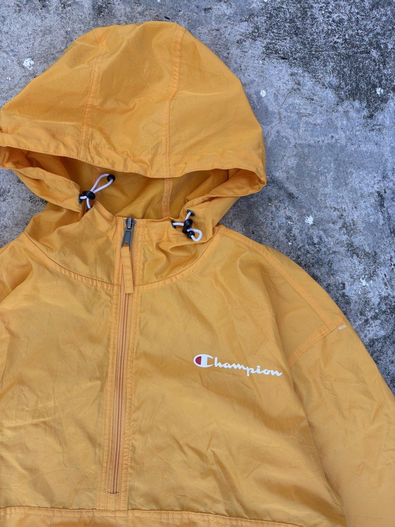 Champion Yellow Anorak Windbreaker Jacket (Category: Coats, Jackets and Outerwear) located in Consolacion. Submitted by hardy_303 (Listing ID 1444380588, Image 3). Description: - Yellow Champion anorak jacket - Hooded with a half-zip closure - Front kangaroo pocket with an additional zip pocket - Elastic cuffs and hem for a snug fit - Small Champion logo details on chest and sleeve - Ideal for layering or protection against light rain.