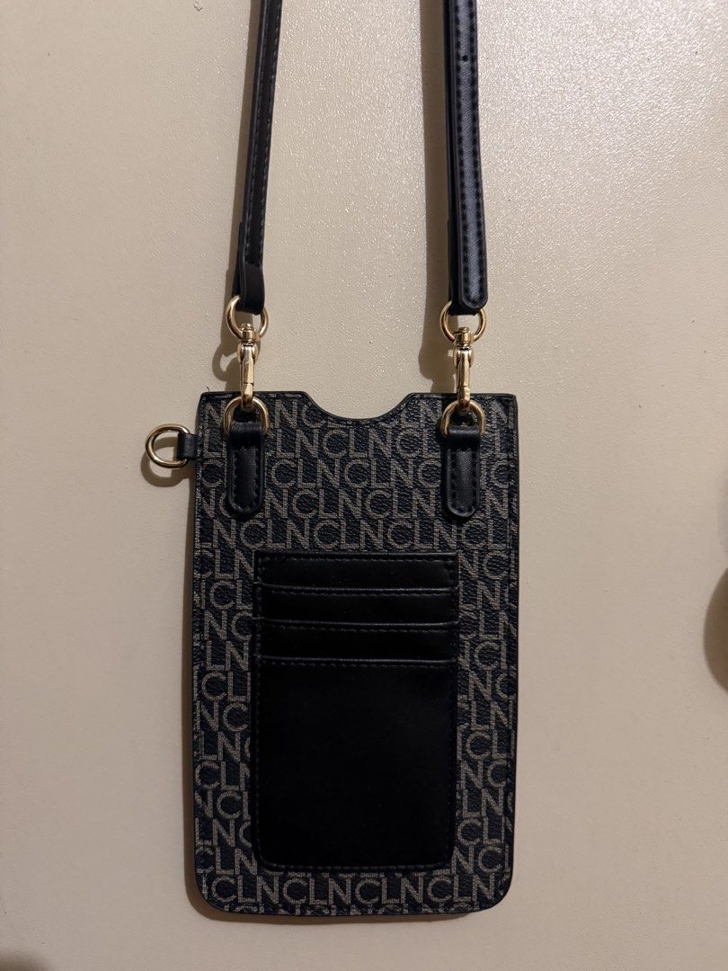 CLN Phone Pouch with Card Slots (Category: Purses & Pouches) located in Cebu City. Submitted by btsandmore (Listing ID 1444425829, Image 1). Description: - Cute phone pouch with repeating CLNCL pattern - Multiple card slots on the front - Includes a long strap for crossbody wear - Ideal for keeping your phone and cards organized and accessible - Easy to carry for everyday use.