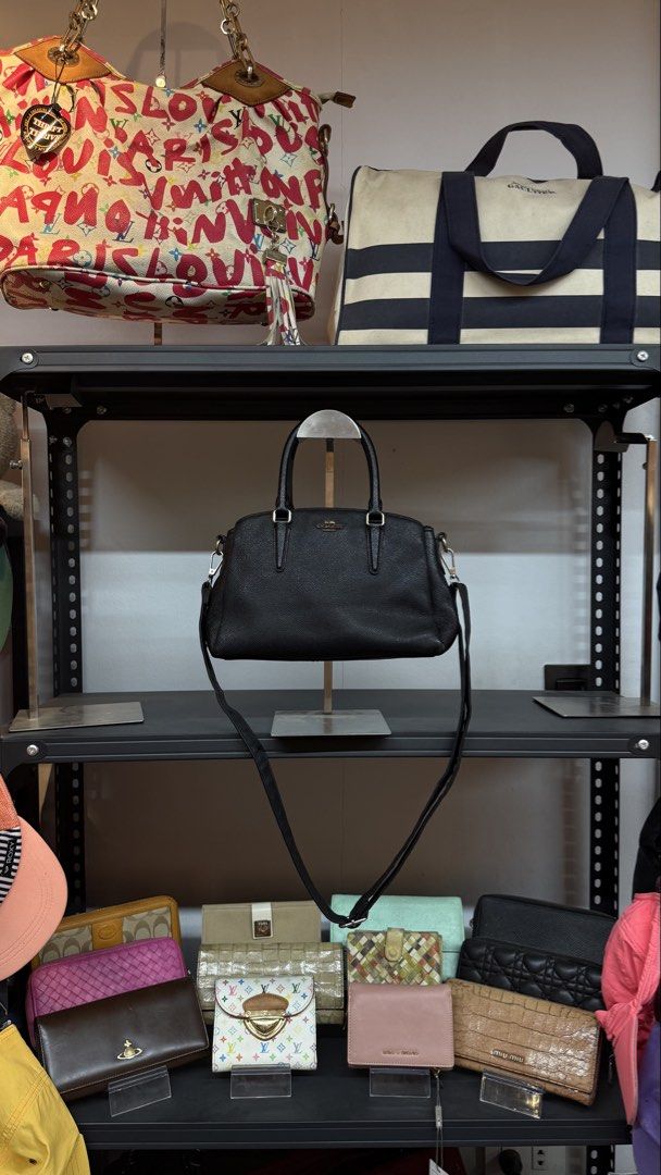 Coach Black Pebbled Leather Satchel Bag (Category: Luxury Bags & Wallets) located in Legazpi City. Submitted by deadthrift (Listing ID 1444458297, Image 1). Description: - Brand: Coach - Material: Black pebbled leather - Style: Satchel - Features: Top handles, detachable shoulder strap, gold hardware, zip closure - Interior: Multiple compartments - Ideal for: Everyday use, carrying essentials.