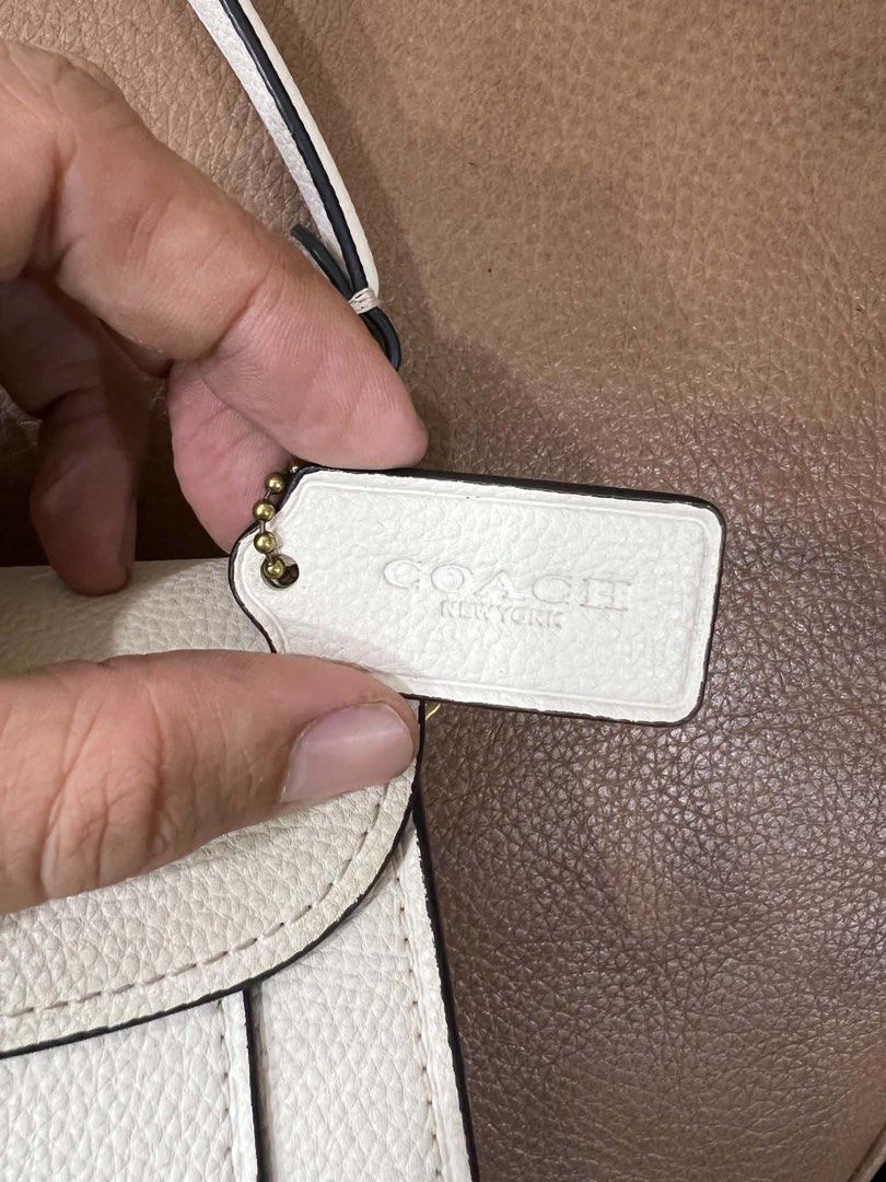 Coach Tabby Shoulder Bag 26 White Pebble Leather (Category: Luxury Bags & Wallets) located in Bacolod City. Submitted by novymaesel14868 (Listing ID 1444418090, Image 3). Description: - White pebble leather Coach bag - Gold iconic C hardware - Secure turn-lock closure - Adjustable strap for comfort - Includes original Coach hangtag - Versatile for daily use or special events - Interior is clean and well-maintained.