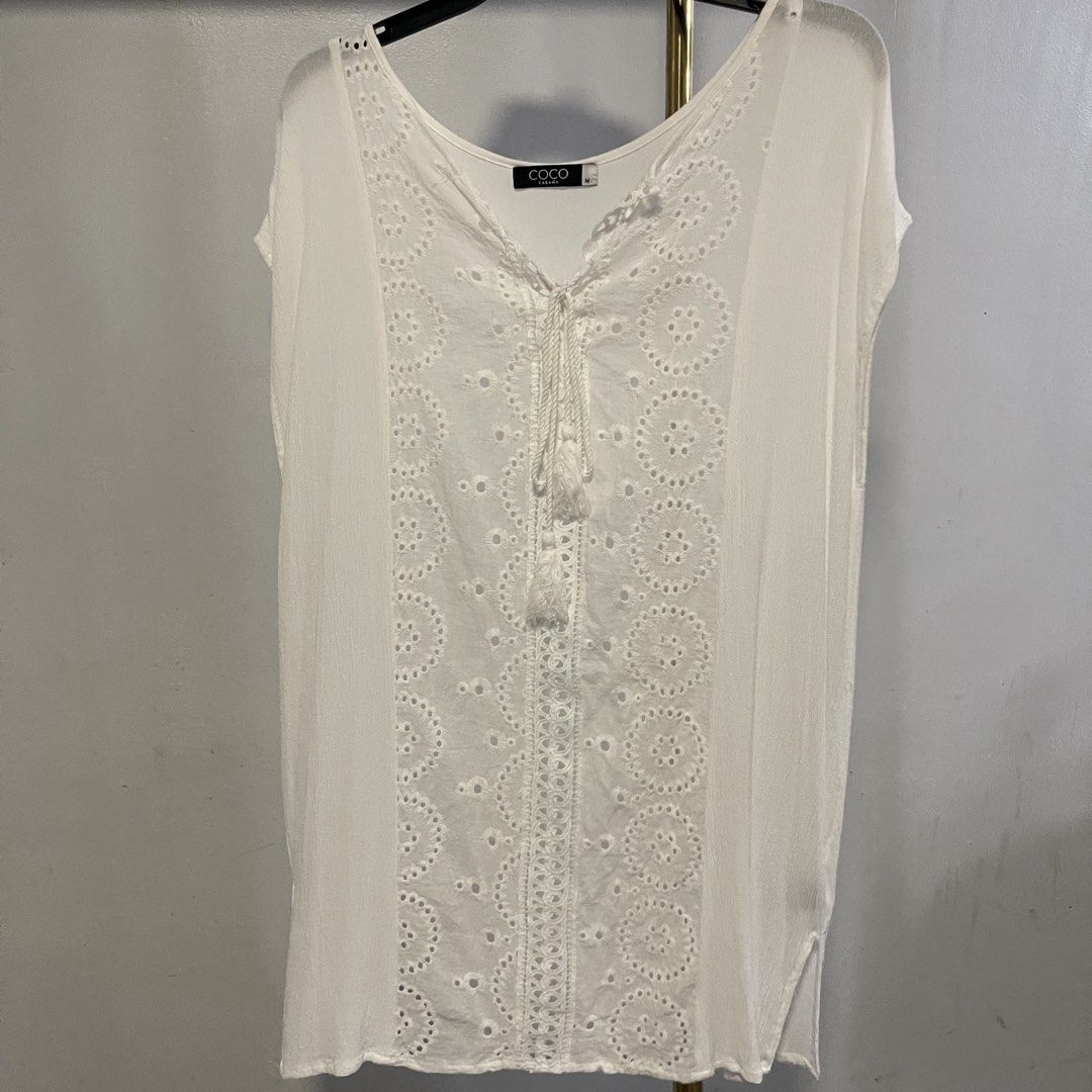 Coco Cabana White Eyelet Tassel Tunic Top Size M (Category: Others Tops) located in General Trias. Submitted by 1992thelabel (Listing ID 1444396224, Image 1). Description: Selling to feed more bellies 🐾 Proceeds go to my rescue dogs, cats & strays. Please respect the price, no much haggling. Thank you 🫶🏻 - Brand: COCO CABANA - Color: White - Style: Tunic Top - Size: Medium (M) - Details: Intricate eyelet embroidery down the front, tassel tie a