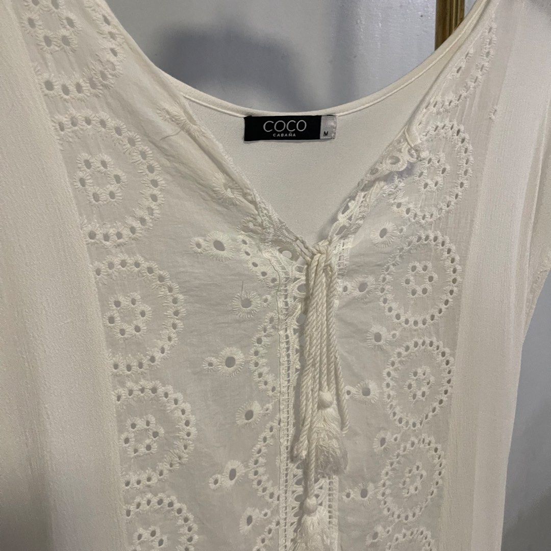 Coco Cabana White Eyelet Tassel Tunic Top Size M (Category: Others Tops) located in General Trias. Submitted by 1992thelabel (Listing ID 1444396224, Image 2). Description: Selling to feed more bellies 🐾 Proceeds go to my rescue dogs, cats & strays. Please respect the price, no much haggling. Thank you 🫶🏻 - Brand: COCO CABANA - Color: White - Style: Tunic Top - Size: Medium (M) - Details: Intricate eyelet embroidery down the front, tassel tie a