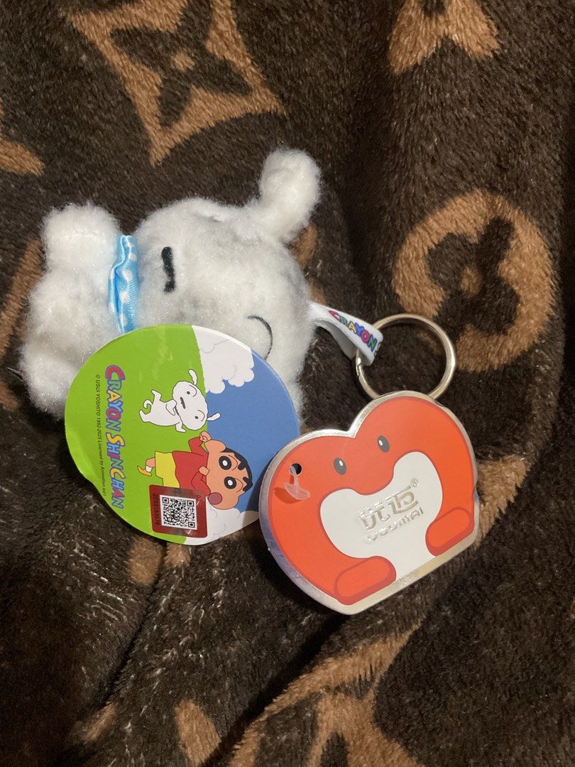 Crayon Shin-chan White Dog Plush Keychain (Category: Plushies & Soft Toys) located in Paranaque City. Submitted by eller_2 (Listing ID 1444489313, Image 2). Description: Shin-chan white dog plush keychain with blue ribbon, heart tag, and keyring. Perfect for bags and keys!.