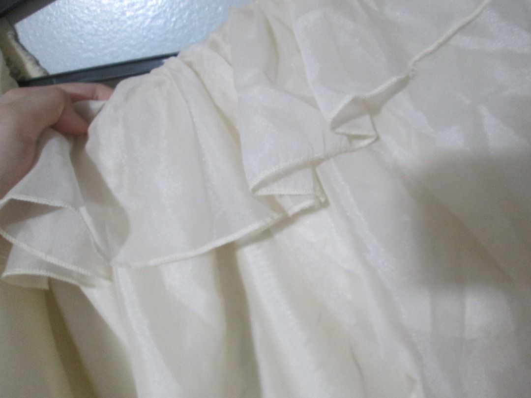 Cream Off-Shoulder Ruffle Puff Sleeve Top (Category: Blouses) located in Quezon City. Submitted by leftoversclub (Listing ID 1444383967, Image 2). Description: Cream colored top with an off-shoulder neckline. Features ruffles across the chest and puff sleeves. The fabric has a slight sheen. Great for a casual or dressy occasion. Shipping fee is shouldered by the buyer..