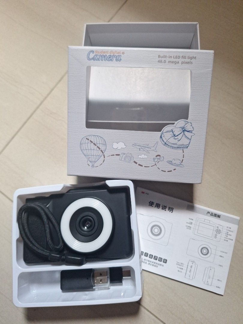 Digital Camera (Category: Cameras) located in Singapore. Submitted by foundatmine (Listing ID 1444374975, Image 1). Description: - Compact digital camera - Built-in LED ring light for perfect selfies, High resolution: 48.0 megapixels - Screen flips out for easy viewing - Good for kids as a starter camera / casual photography - Includes USB charging cable, transferring, manual and a pouch. Meetup: Tanah Merah MRT Mailing +$3 (do lmk as may not be 