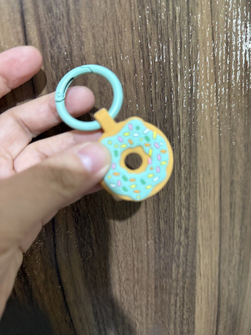 Donut Keychain with Teal Ring for apple airtag (Category: Other Accessories) located in Batangas. Submitted by pixie_clearance (Listing ID 1444435693, Image 1). Description: - Adorable donut keychain - Features a teal ring attachment - Comes with a fun orange silicone donut cover - Ideal for apple airtag.