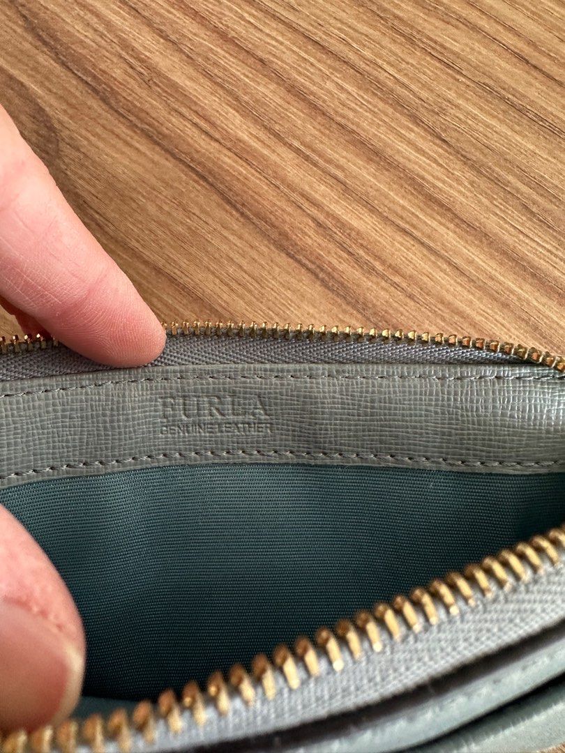Furla Genuine Leather Cardholder (Category: Wallets & Card holders) located in Quezon City. Submitted by nancdmd (Listing ID 1444426997, Image 3). Description: Light blue Furla cardholder. Made of genuine leather. Has a zip closure and a front slip pocket. Also features card slots on the back. Gold hardware details. Compact and practical for everyday use..