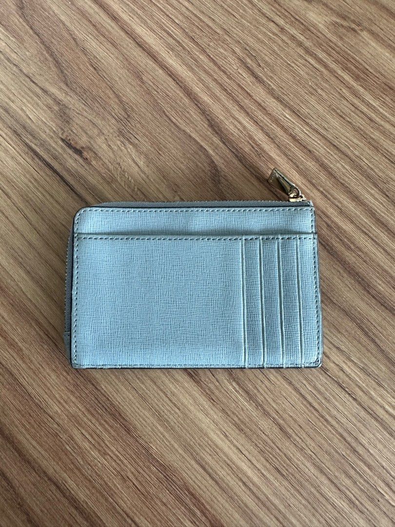 Furla Genuine Leather Cardholder (Category: Wallets & Card holders) located in Quezon City. Submitted by nancdmd (Listing ID 1444426997, Image 2). Description: Light blue Furla cardholder. Made of genuine leather. Has a zip closure and a front slip pocket. Also features card slots on the back. Gold hardware details. Compact and practical for everyday use..