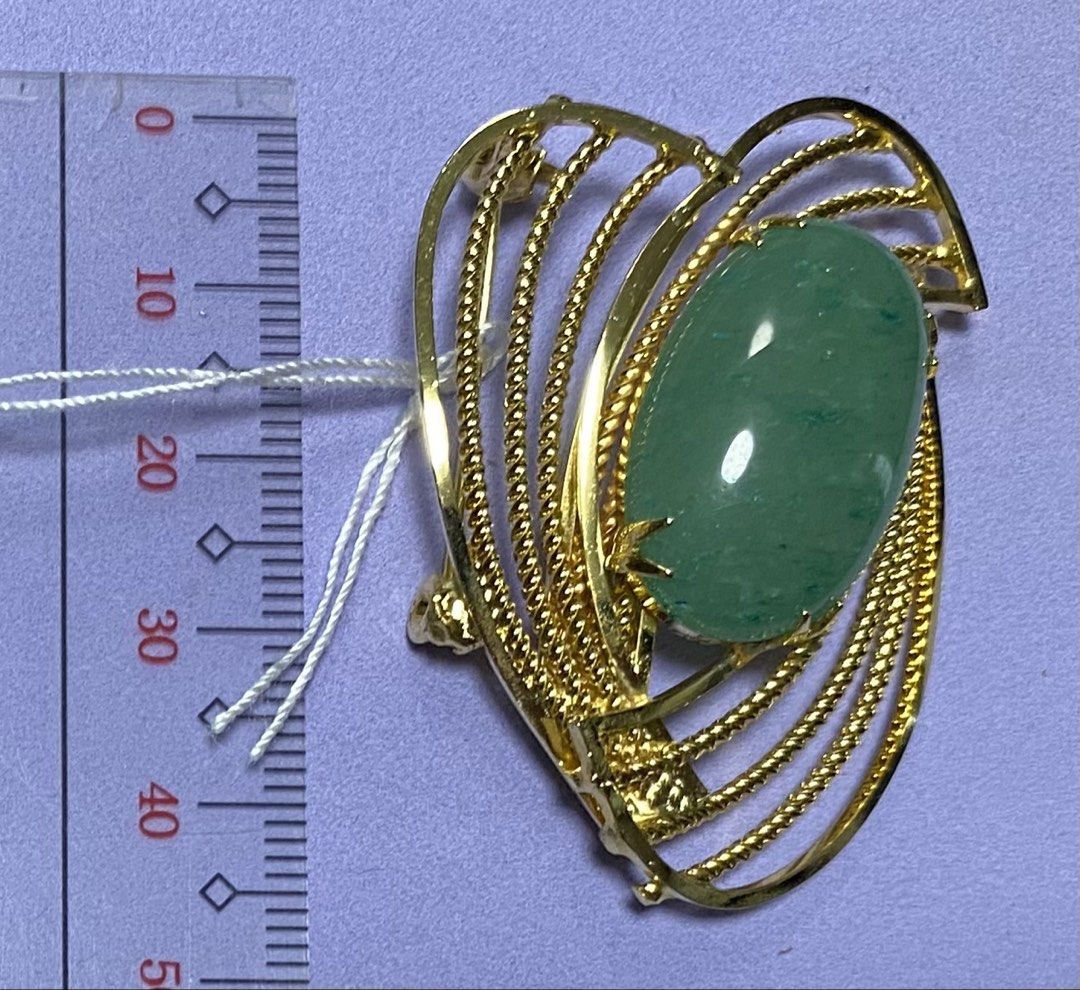 Gold Heart Brooch with Green Stone (Category: Brooches) located in Mabalacat. Submitted by somethingoldsomethingnew28 (Listing ID 1444353980, Image 1). Description: - Elegant gold-tone heart-shaped brooch. - Features a prominent, smooth, polished oval green stone at the center. - Intricate twisted wire design on the gold metalwork. - Secure pin closure on the back. - Approximate dimensions: 4.5 cm in length..