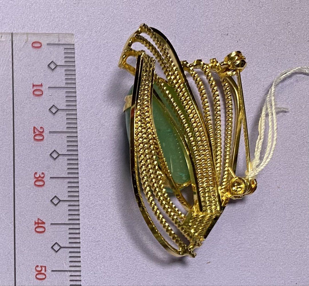 Gold Heart Brooch with Green Stone (Category: Brooches) located in Mabalacat. Submitted by somethingoldsomethingnew28 (Listing ID 1444353980, Image 2). Description: - Elegant gold-tone heart-shaped brooch. - Features a prominent, smooth, polished oval green stone at the center. - Intricate twisted wire design on the gold metalwork. - Secure pin closure on the back. - Approximate dimensions: 4.5 cm in length..