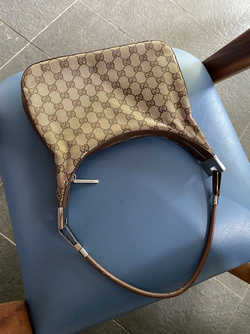 SALE! Gucci Monogram Canvas Mini Hobo (Category: Luxury Bags & Wallets) located in Santa Rosa. Submitted by happydays__ (Listing ID 1444319890, Image 3). Description: - Classic Gucci canvas mini hobo shoulder bag - Iconic GG monogram canvas - Brown leather trim and strap - Zipper closure - Interior zip pocket - some signs of wear on leather strap and trim.