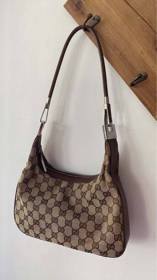 SALE! Gucci Monogram Canvas Mini Hobo (Category: Luxury Bags & Wallets) located in Santa Rosa. Submitted by happydays__ (Listing ID 1444319890, Image 1). Description: - Classic Gucci canvas mini hobo shoulder bag - Iconic GG monogram canvas - Brown leather trim and strap - Zipper closure - Interior zip pocket - some signs of wear on leather strap and trim.
