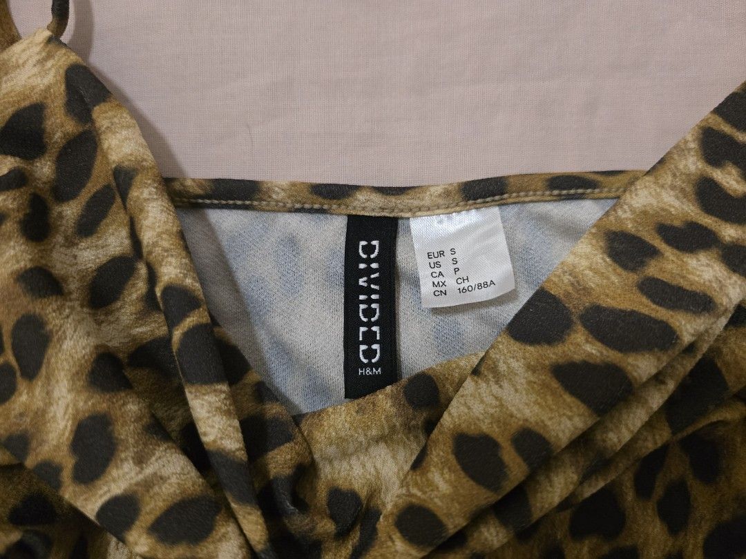 H&M Divided Leopard Print Cowl Neck Camisole Top (Category: Sleeveless) located in Manila. Submitted by yzahmae (Listing ID 1444420537, Image 2). Description: - Cute leopard print camisole from H&M Divided - Features a stylish cowl neck - Ruched sides for a flattering fit - Adjustable spaghetti straps - Stretchy and comfortable material - Perfect for layering or wearing solo.