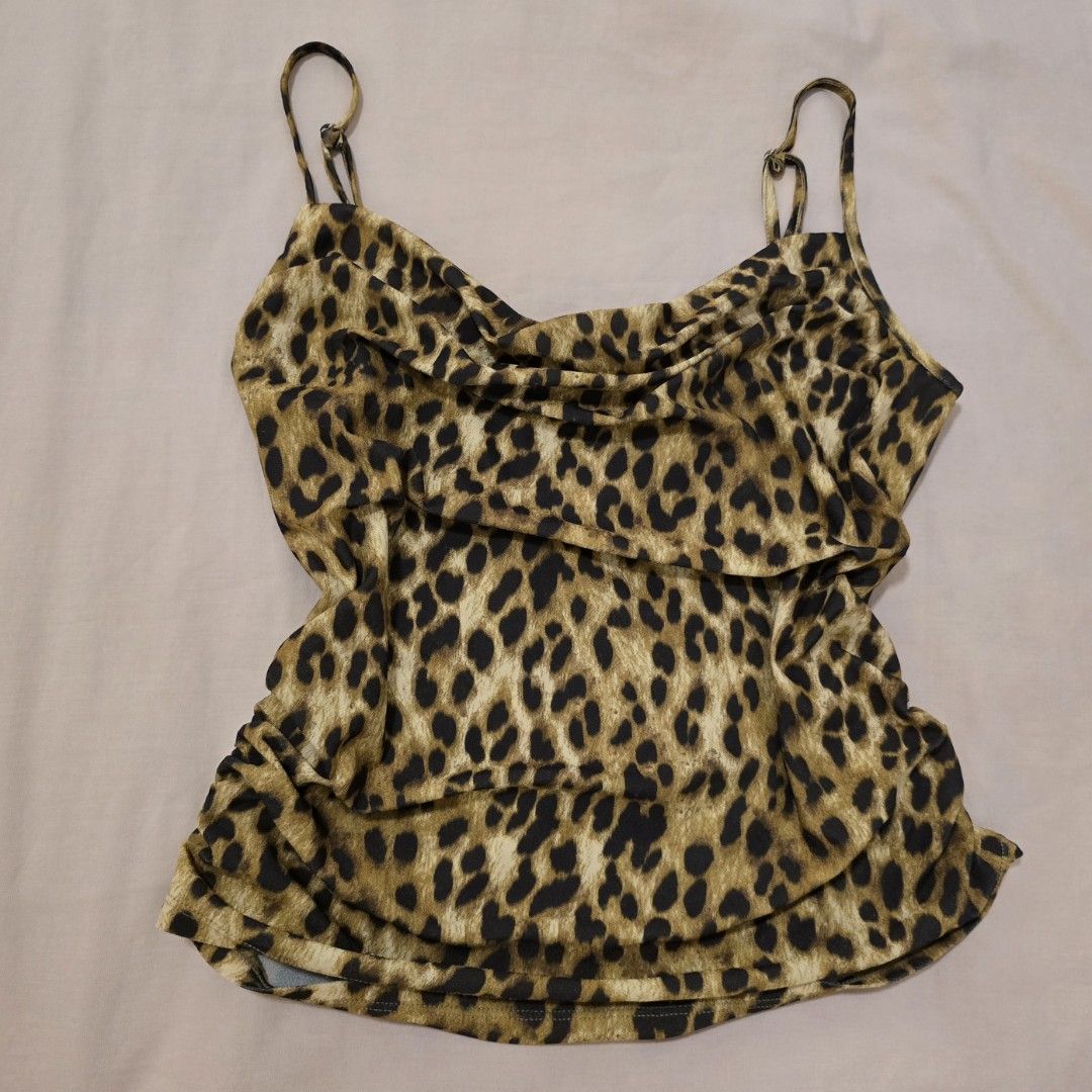 H&M Divided Leopard Print Cowl Neck Camisole Top (Category: Sleeveless) located in Manila. Submitted by yzahmae (Listing ID 1444420537, Image 1). Description: - Cute leopard print camisole from H&M Divided - Features a stylish cowl neck - Ruched sides for a flattering fit - Adjustable spaghetti straps - Stretchy and comfortable material - Perfect for layering or wearing solo.