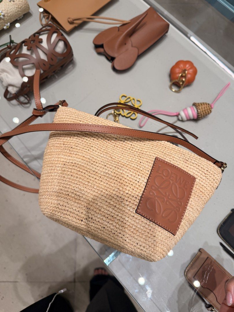 Loewe Raffia Ibiza Basket Bag (Category: Luxury Bags & Wallets) located in Taguig. Submitted by sourcedbym (Listing ID 1444321053, Image 3). Description: - Loewe raffia bag with leather trim - Secure zip closure - Iconic Anagram logo on the front - Ideal for summer wear - Includes a long strap for crossbody style - Approximately 20cm in width.