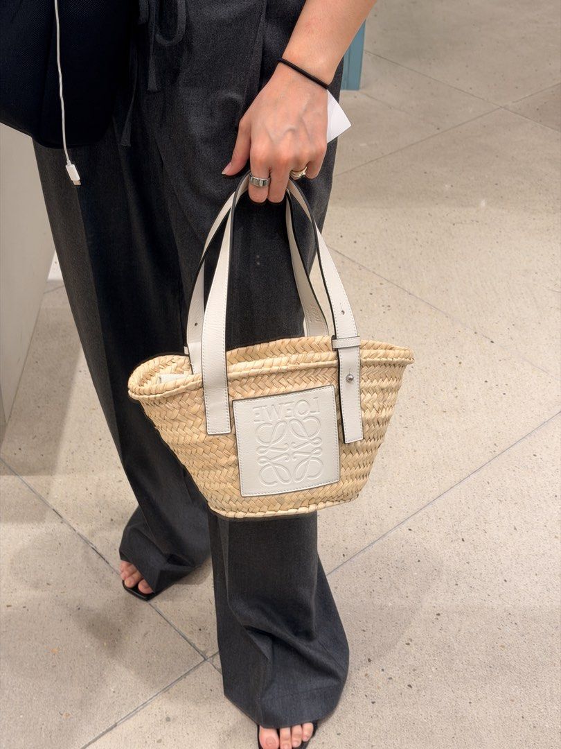 Loewe Straw Basket Bag with White Leather Trim (Category: Luxury Bags & Wallets) located in Taguig. Submitted by sourcedbym (Listing ID 1444320997, Image 1). Description: - Cute Loewe straw basket bag - White leather details - Embossed Loewe logo - Perfect size for essentials - Great for summer outings or beach days - Stylish accessory.
